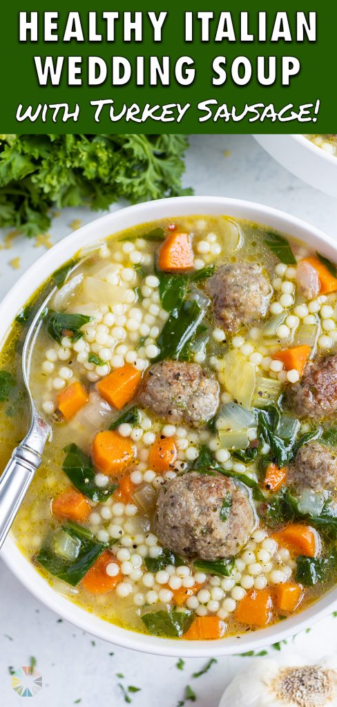 Italian wedding soup is served in a little white bowl.
