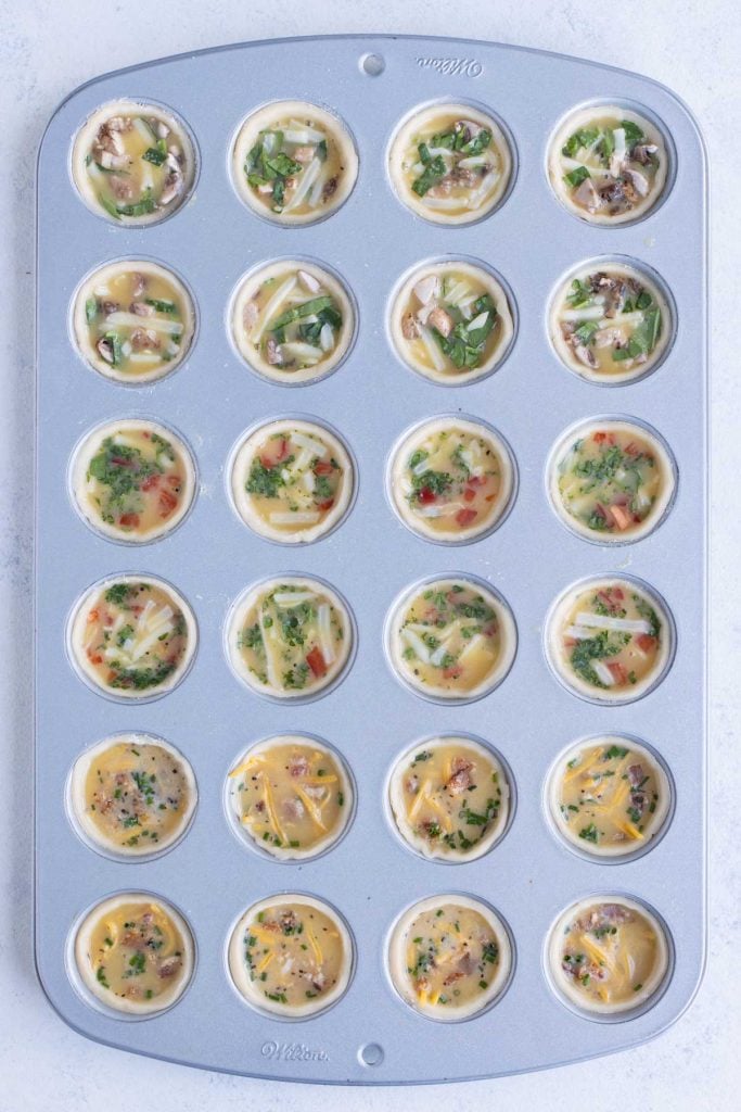 A mini muffin pan is filled and baked in the oven.