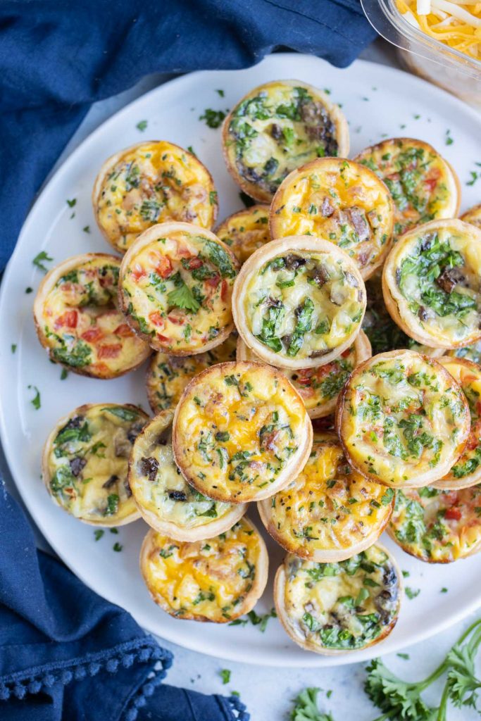 An overhead shot is used to show a plate of mini quiches.