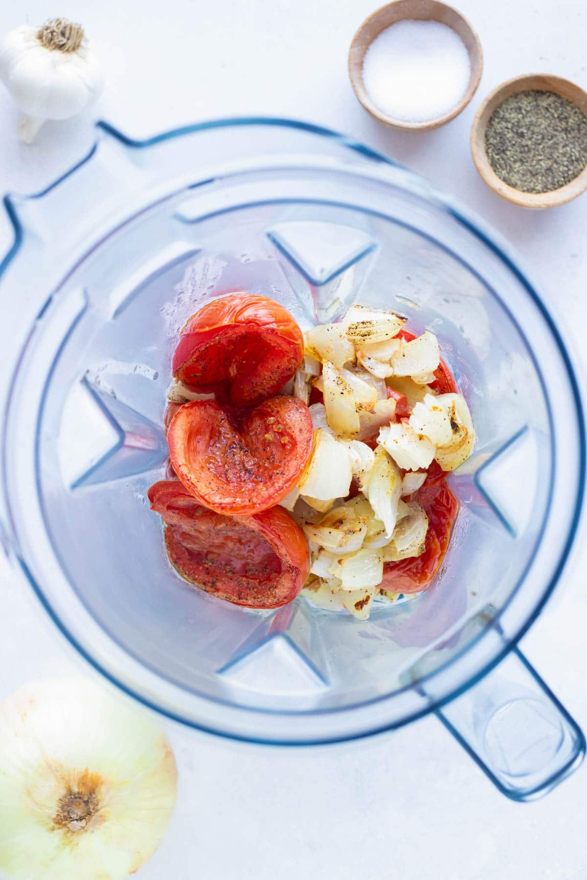 Ingredients in a Vitamix to be blended for a roasted tomato soup.