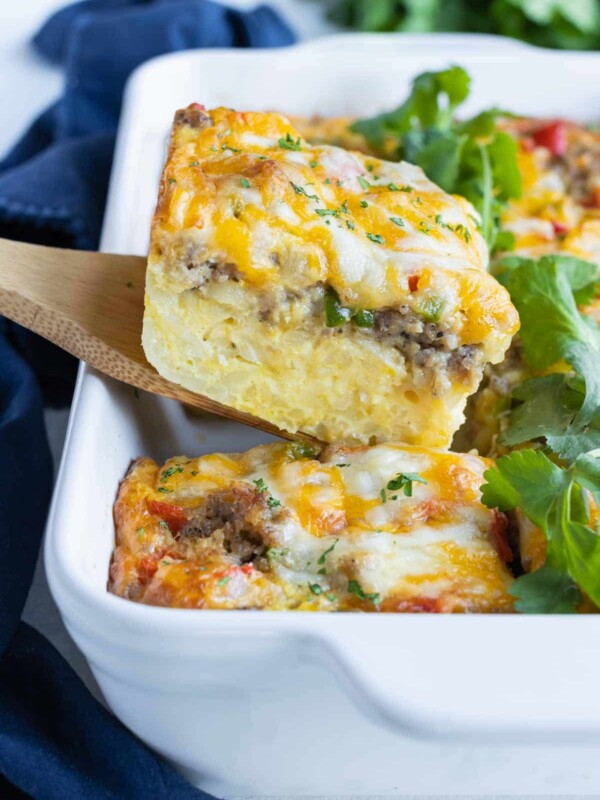 A piece of breakfast casserole is lifted out of the dish.