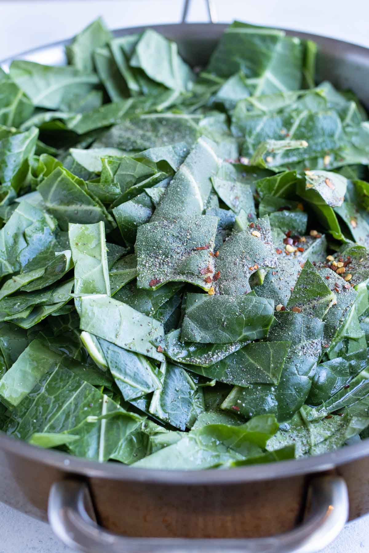 Leaves are added to the pan on the stove.