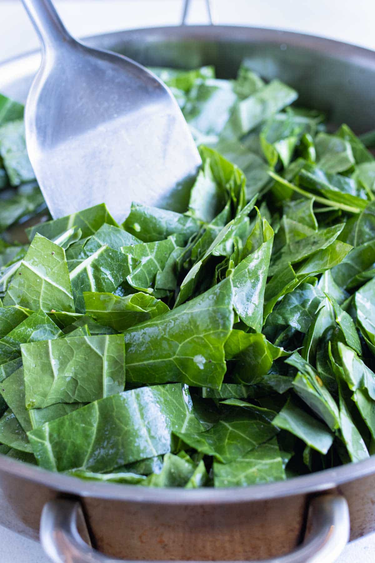 Collard greens are mixed around the pan.