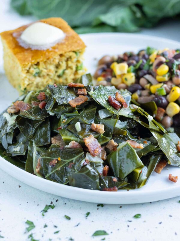 Southern collard greens are served with a side of corn bread.
