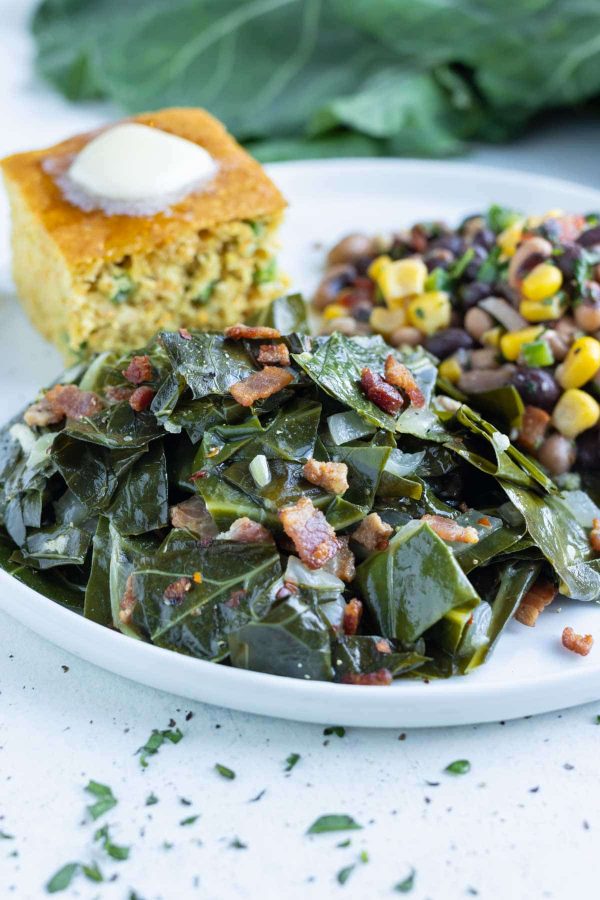 Southern collard greens are served with a side of corn bread.
