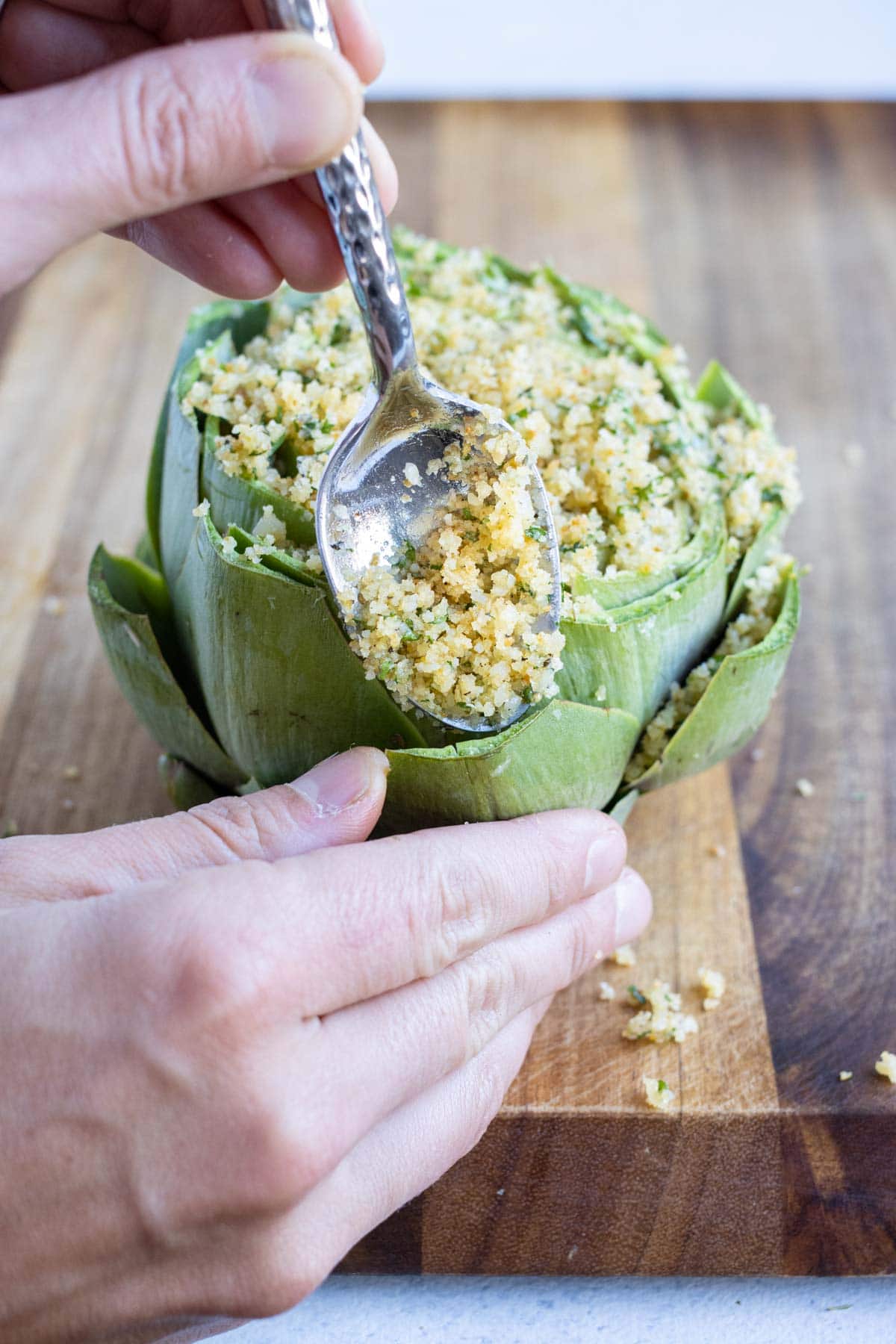 Artichoke is topped with breadcrumb and parmesan mixture.