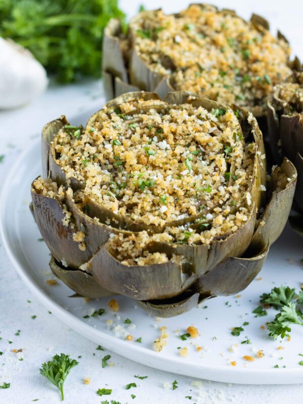 Oven-baked stuffed artichokes are eaten for a holiday appetizer.