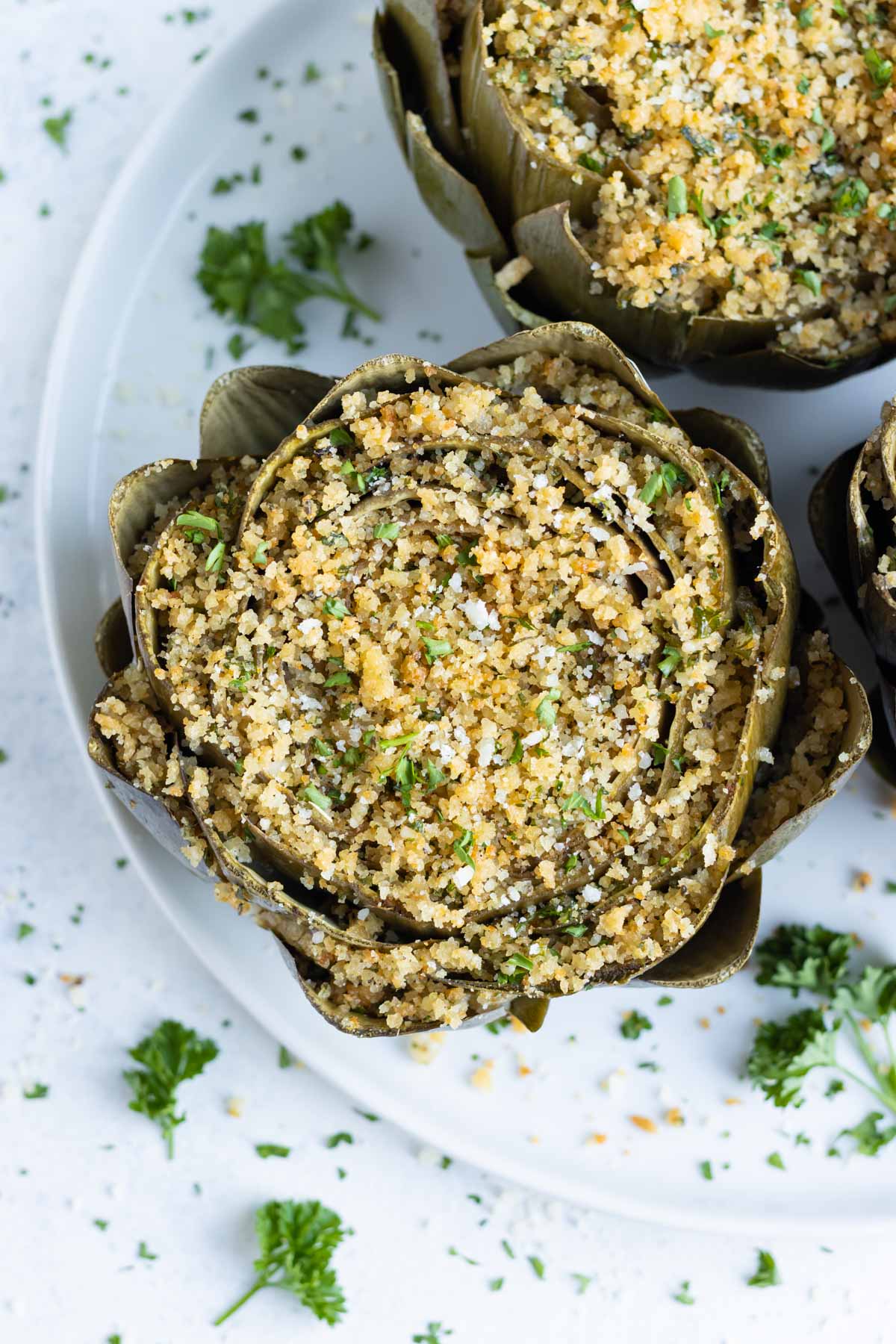 An overhead shot shows stuffed artichokes on a plate.