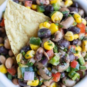 A bowl of easy Texas Caviar (Cowboy Caviar) with black-eyed peas, corn, and peppers, served as a dip or side dish.