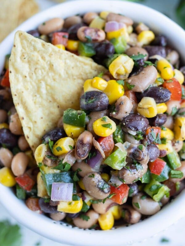 A bowl of easy Texas Caviar (Cowboy Caviar) with black-eyed peas, corn, and peppers, served as a dip or side dish.