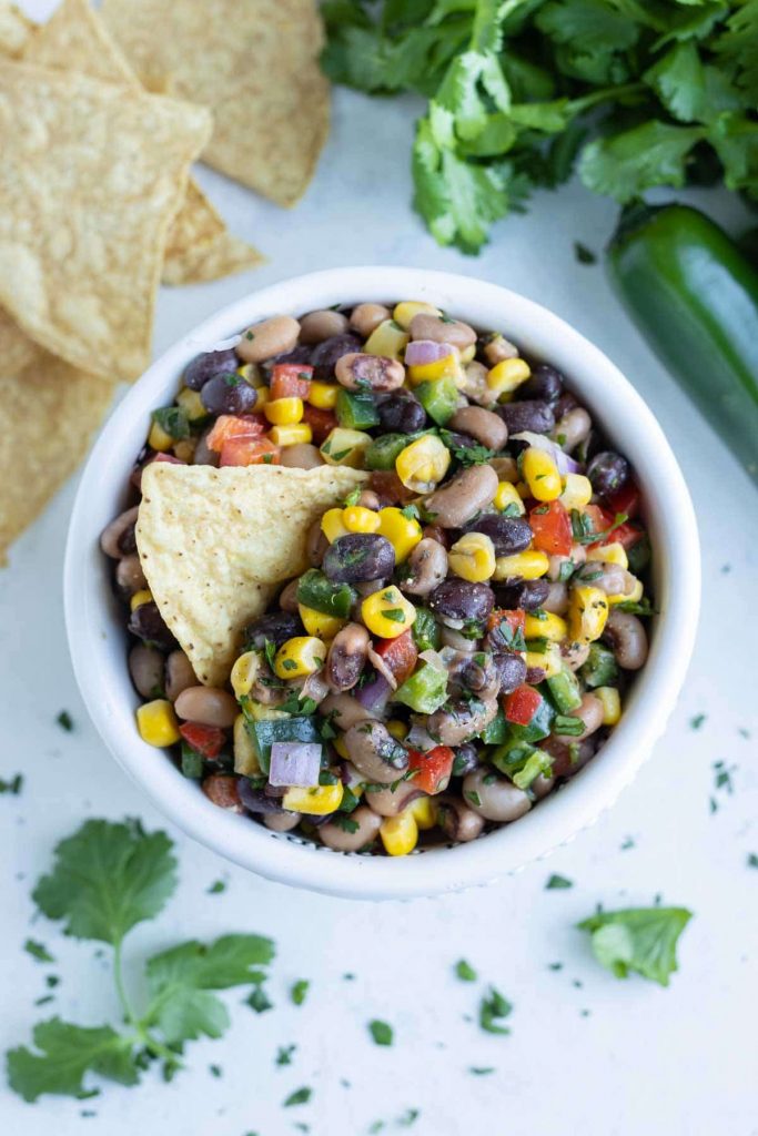 A chip is used to eat this bean and corn dip.