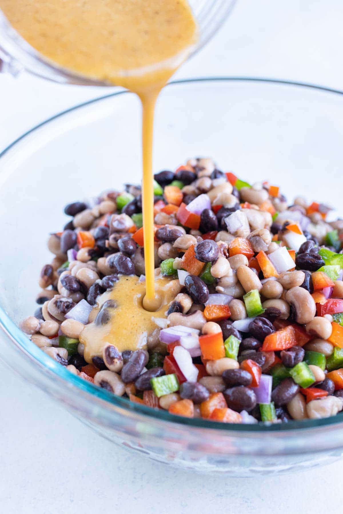 Dressing is poured over the caviar ingredients.