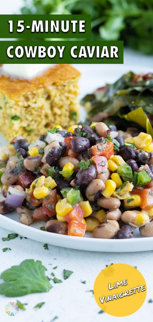 A white plate is filled with Texas caviar, cornbread, and collard greens.