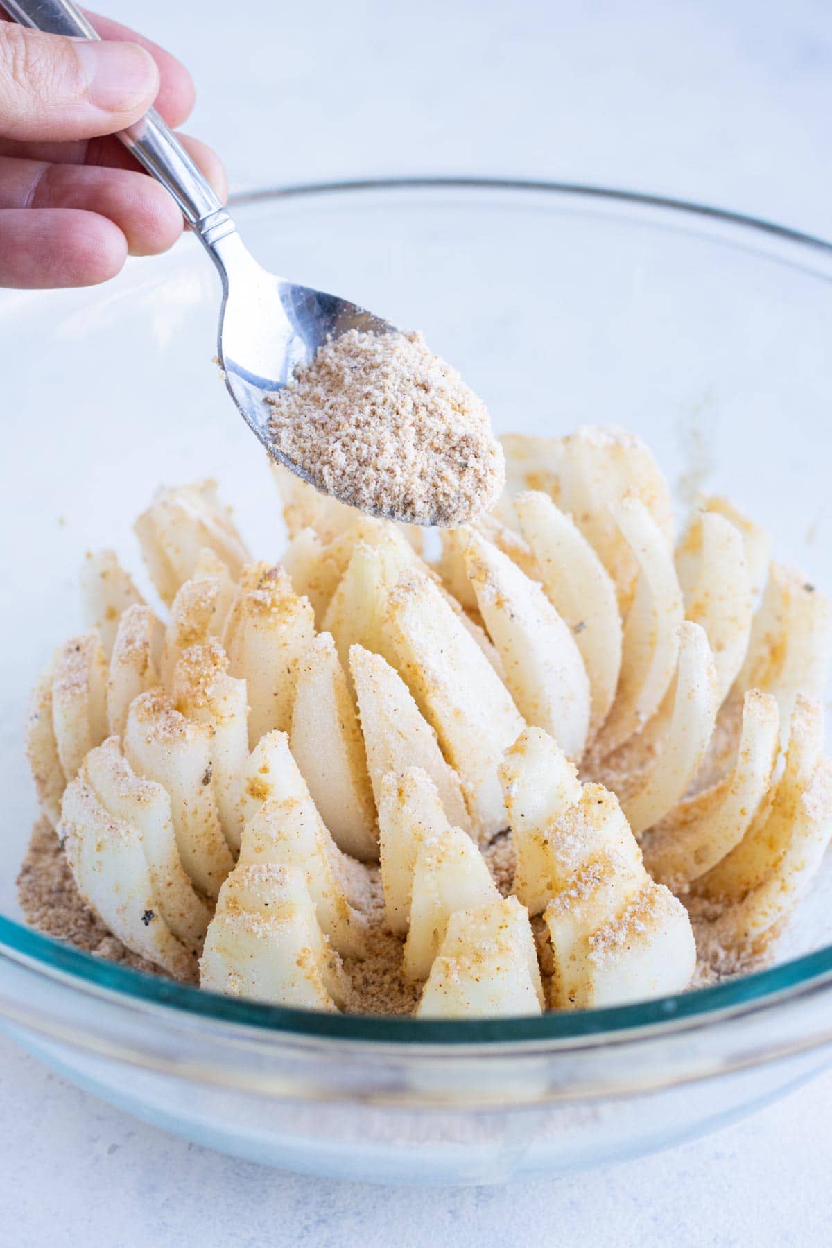 Breadcrumb mixture is sprinkled on top of the onion.