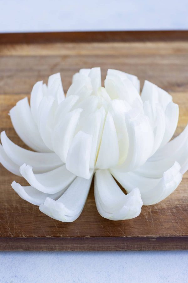 The onion layers are pulled apart so that it looks like a flower.