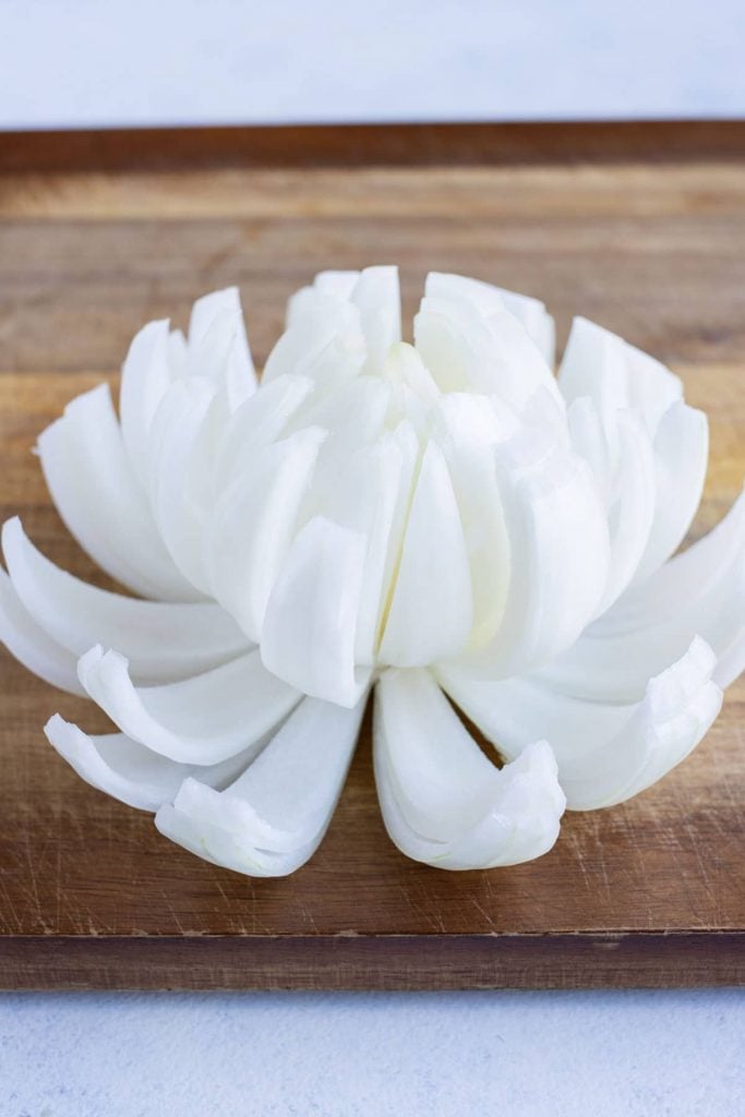 The onion layers are pulled apart so that it looks like a flower.