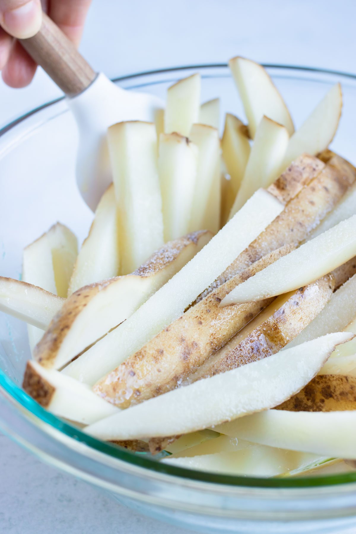 All the french fries are coated in oil and salt.