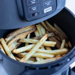 Crispy french fries are cooked in a Ninja air fryer.