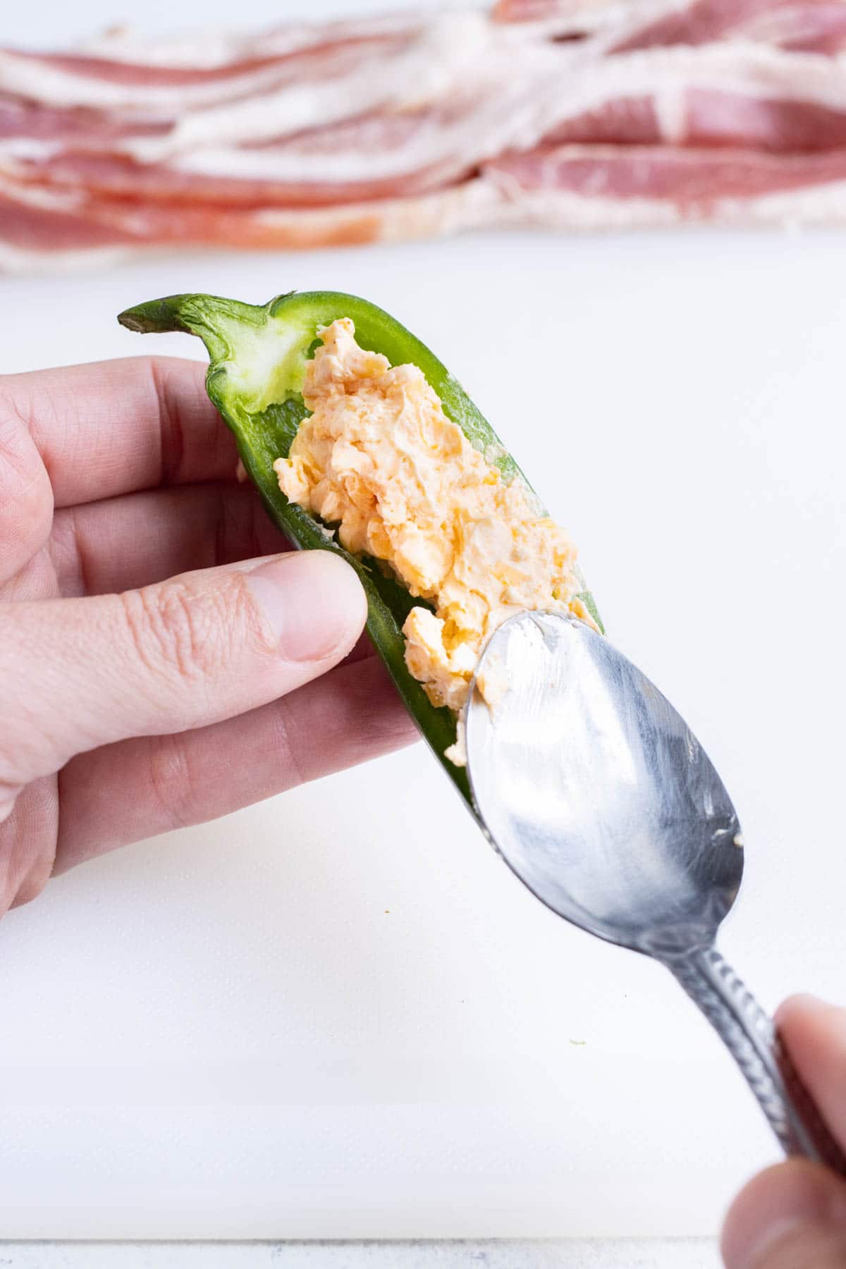Cream cheese filling is added to the jalapeno.