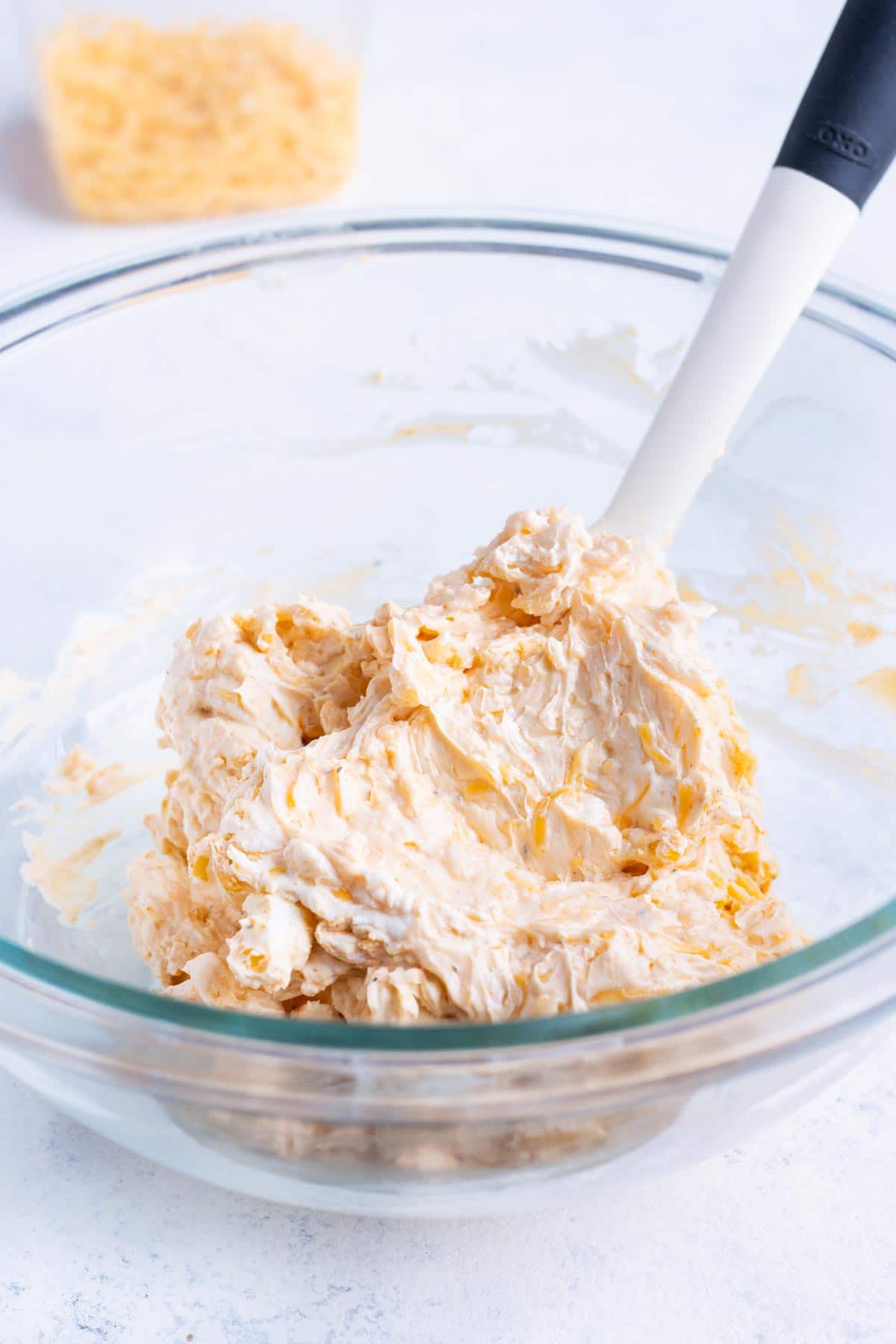 Softened cream cheese is mixed with the seasonings and shredded cheese.