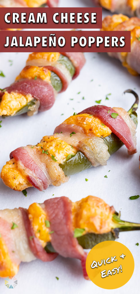 Bacon wrapped jalapeno poppers are topped with parsley before serving.