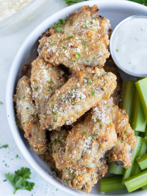 Parmesan garlic chicken wings are served on a plate.