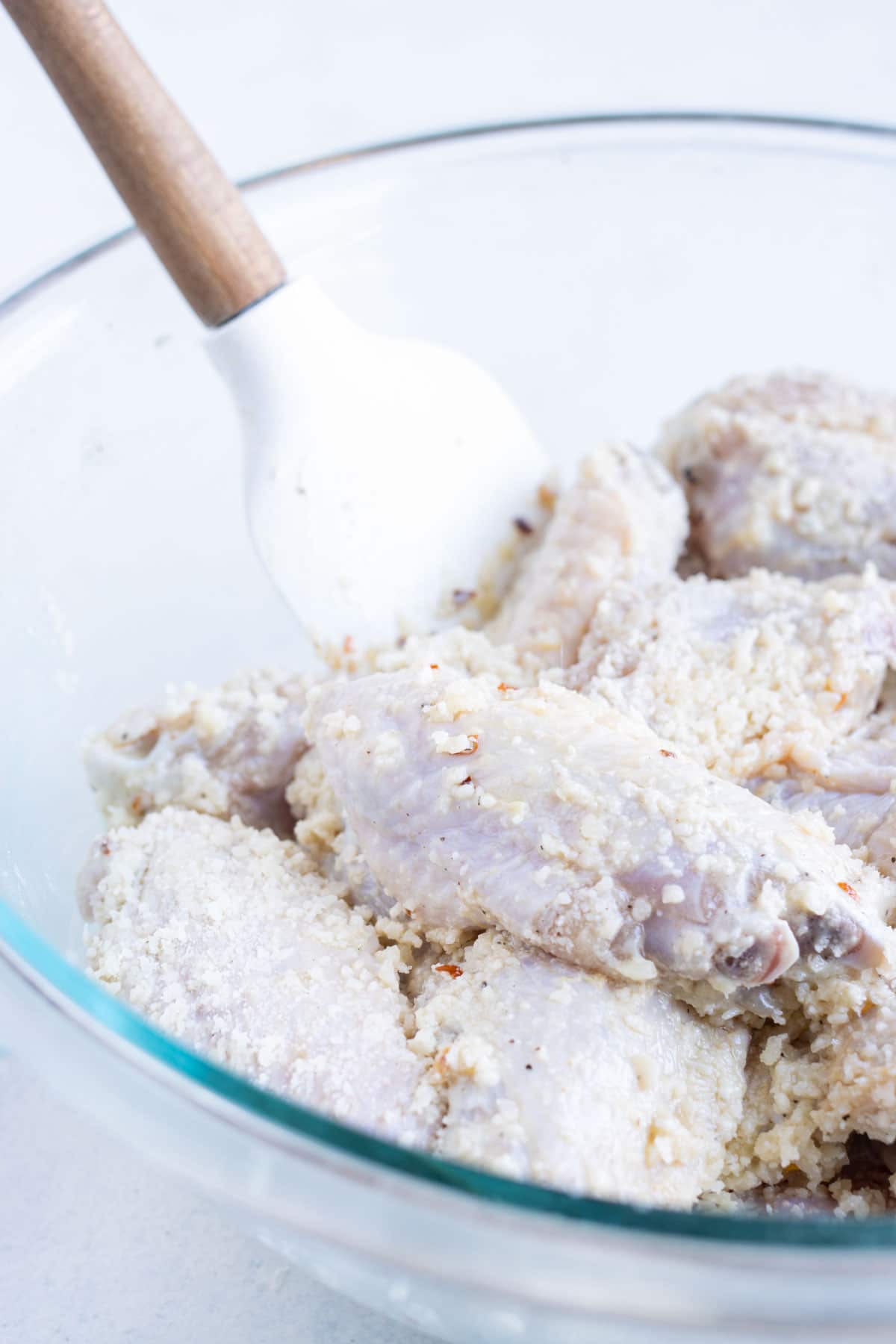 Wings are coated completely in cornstarch and parmesan.