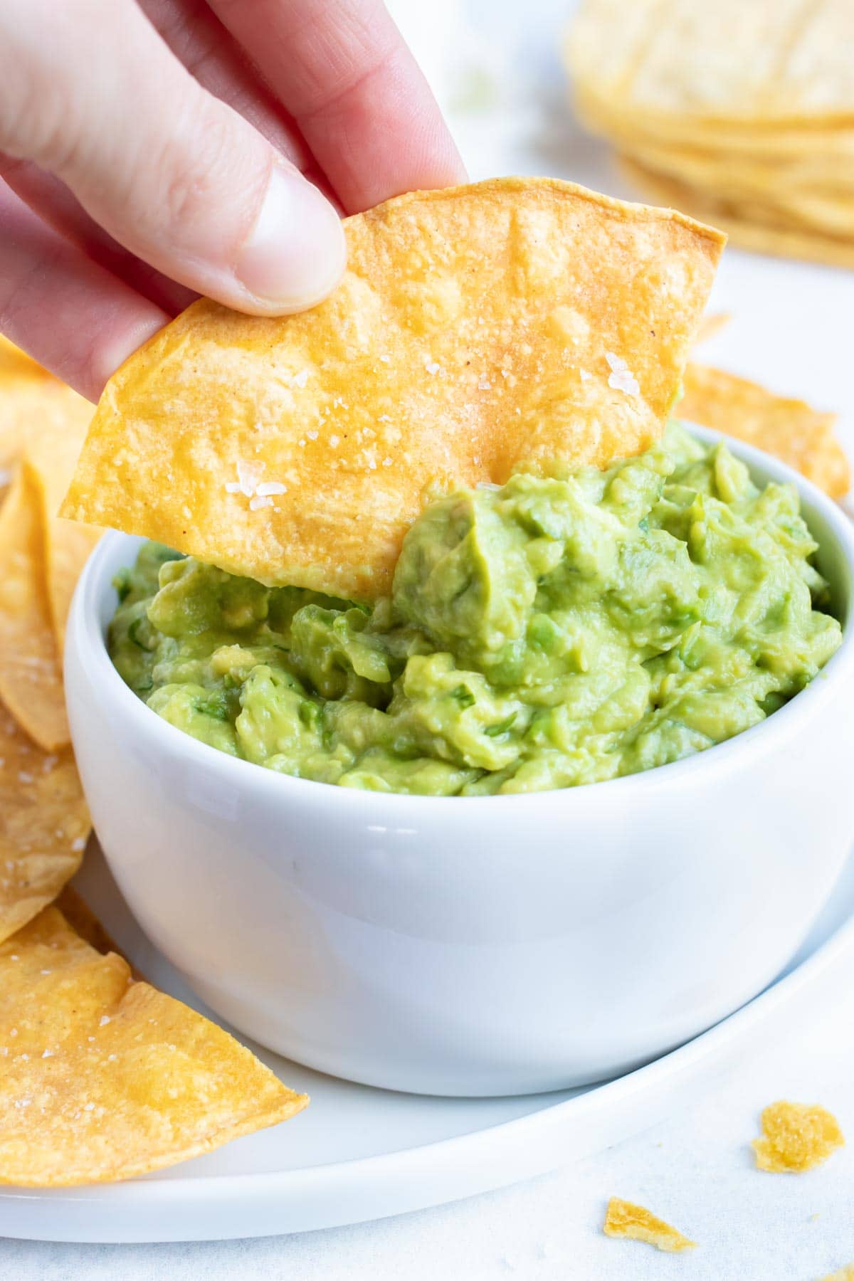 A chip being dipped into guacamole.