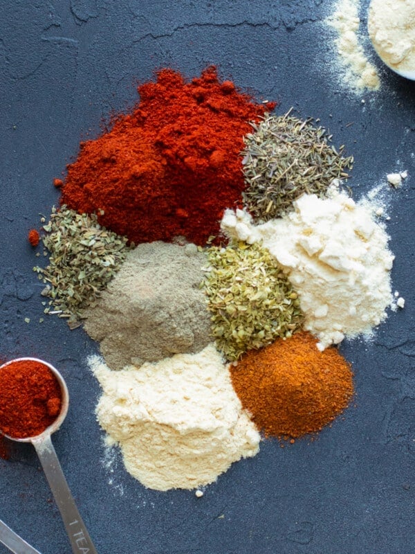 Paprika, cayenne pepper, garlic powder, oregano, thyme, salt and pepper on a board to make a blackening seasoning mix.
