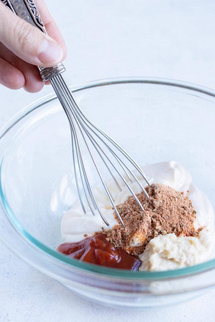 Mayo, ketchup and horseradish measured into a bowl for blooming onion dipping sauce.