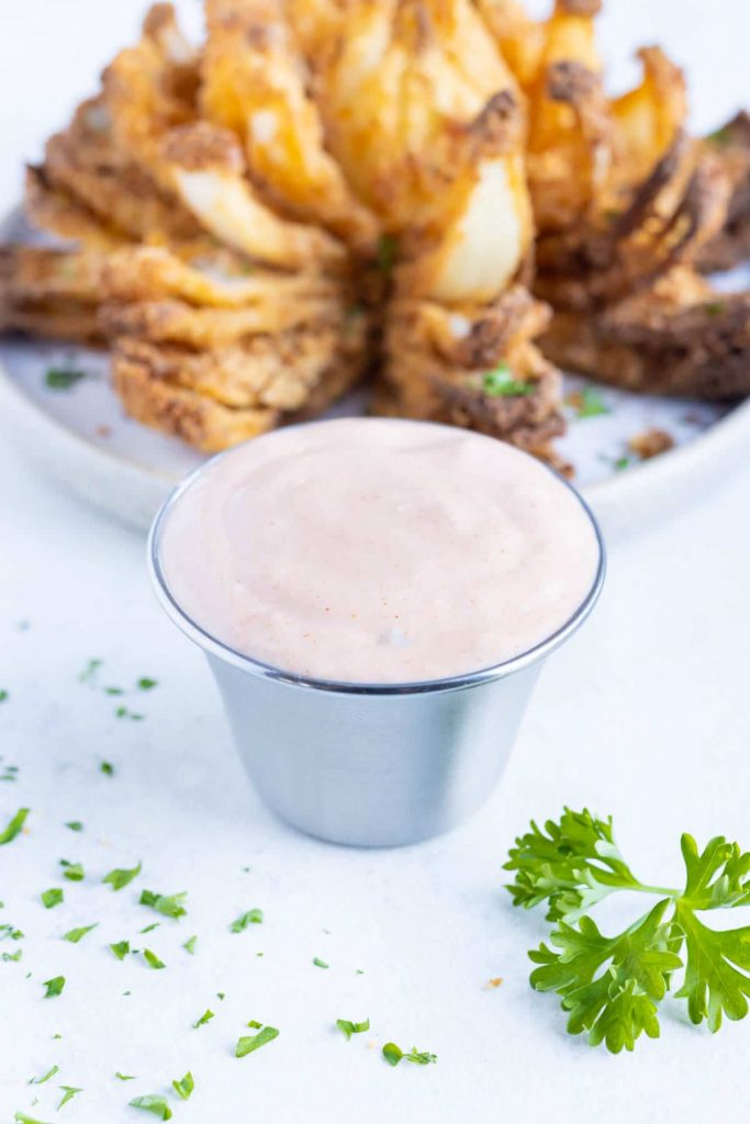 Easy homemade blooming onion sauce is shown in a metal cup.