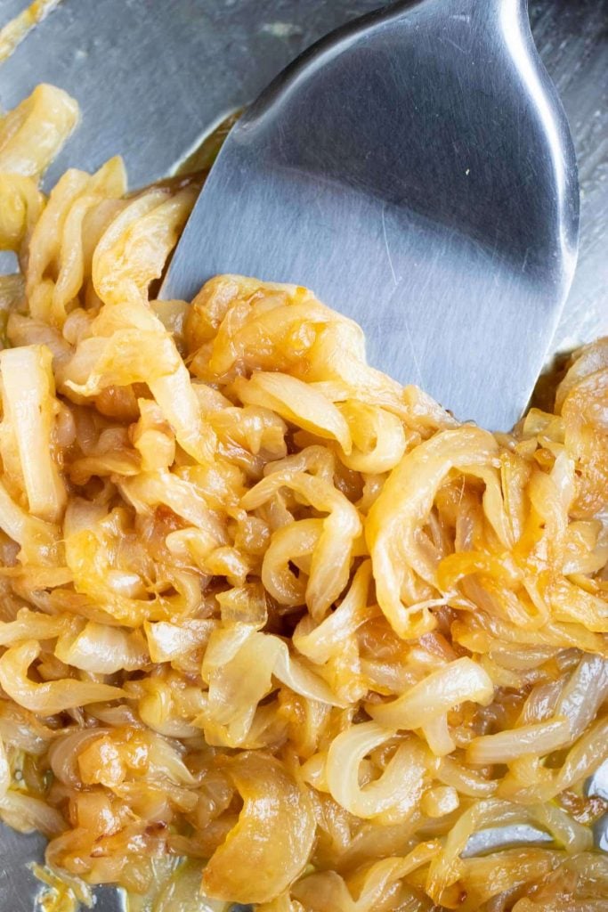 An image showing golden-brown caramelized onions in a skillet.