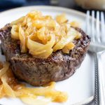 A filet mignon recipe with homemade caramelized onions on top.