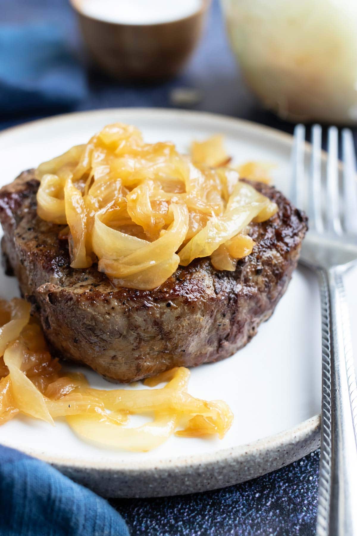 A filet mignon recipe with homemade sautéed onions on top.