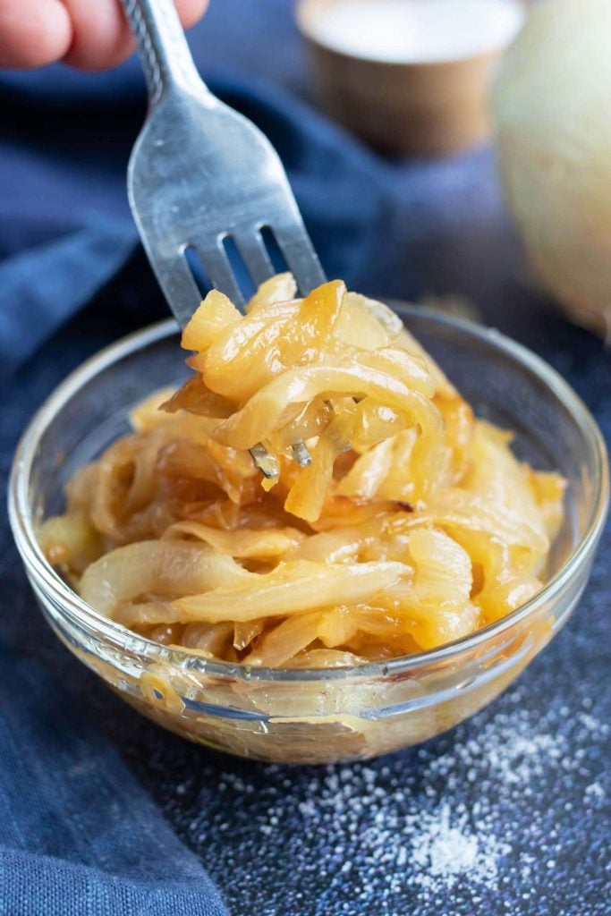 Caramelized onions in a small clear glass bowl.