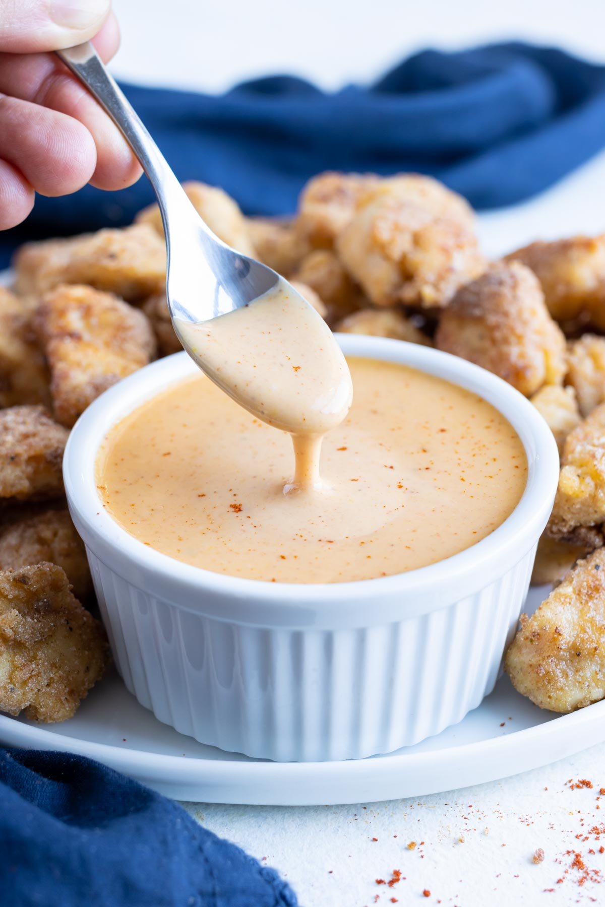 A metal spoon is used to show copycat Chick-fil-A sauce consistency.