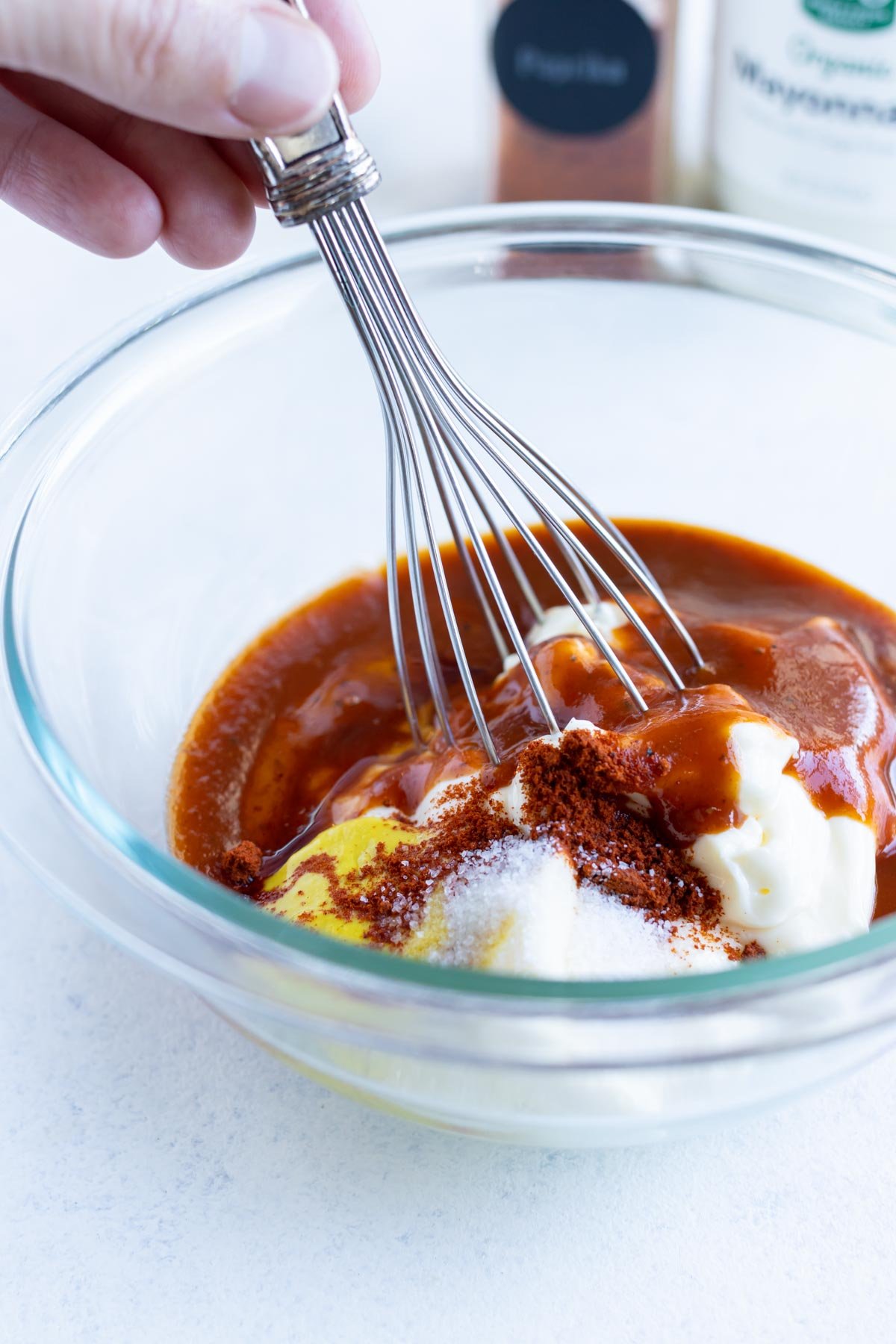 A whisk is used to combine the ingredients in a bowl.