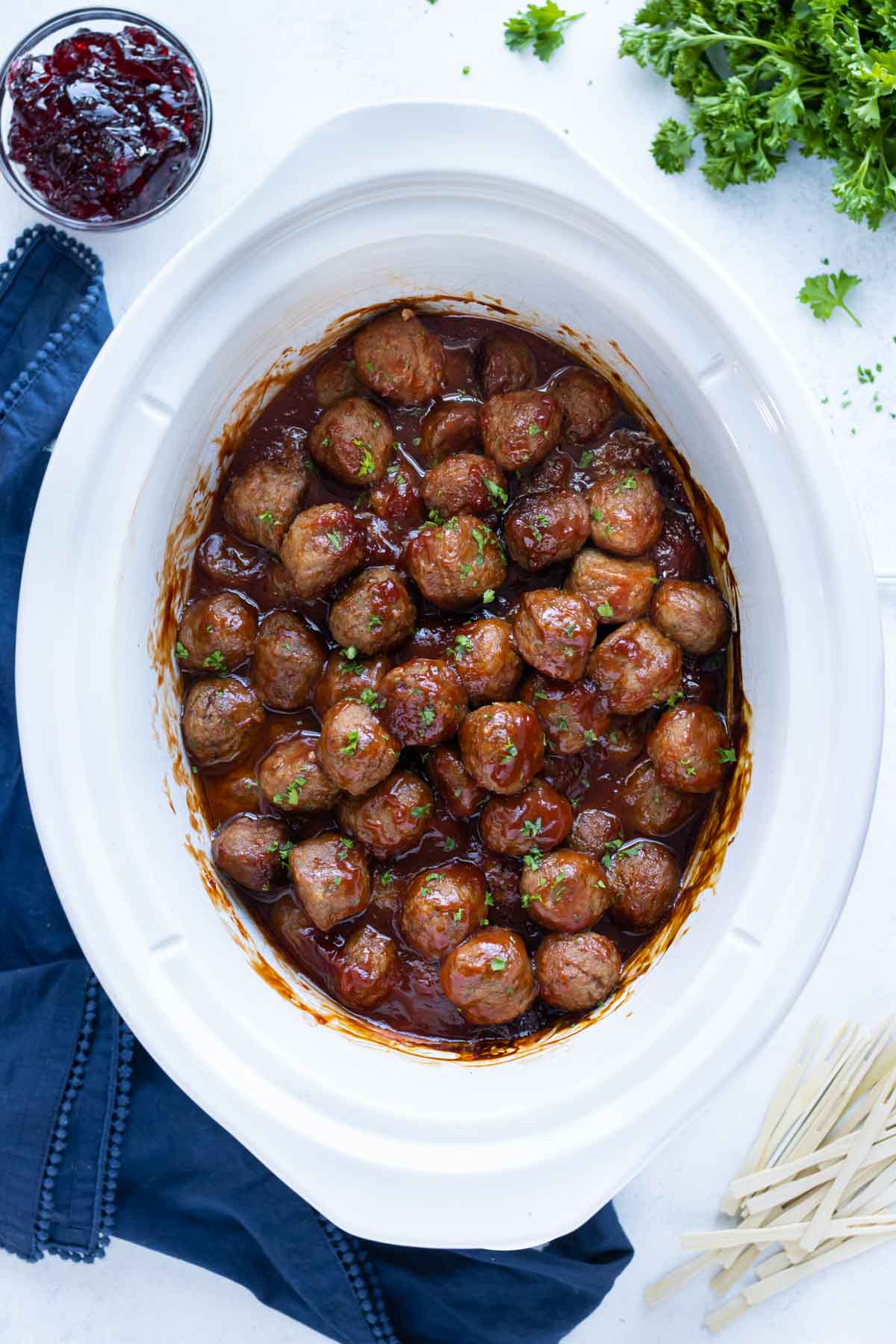 Slow cooker meatballs are show in their delicious sauce.