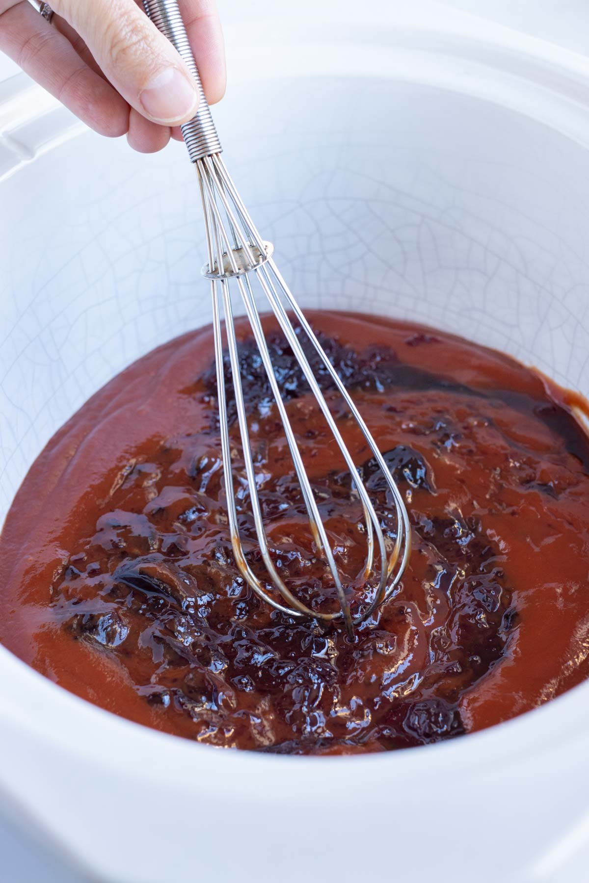 Sauce ingredients are whisked together in the Crockpot.