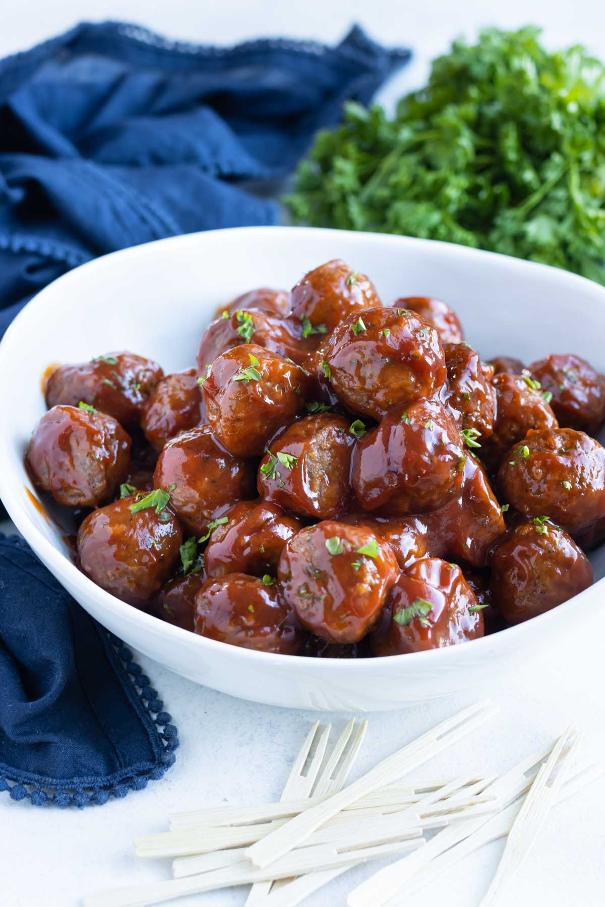 Meatballs are served in a white bowl for an appetizer.