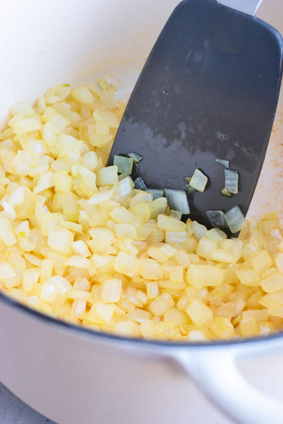 Sauteed onions as an ingredient for a cauliflower soup recipe.