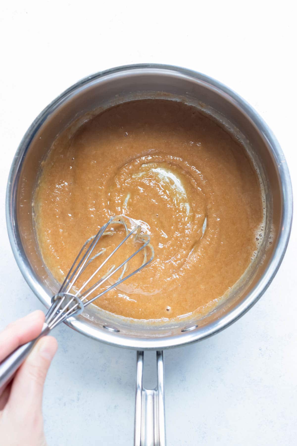 A light brown roux is made on the stove.