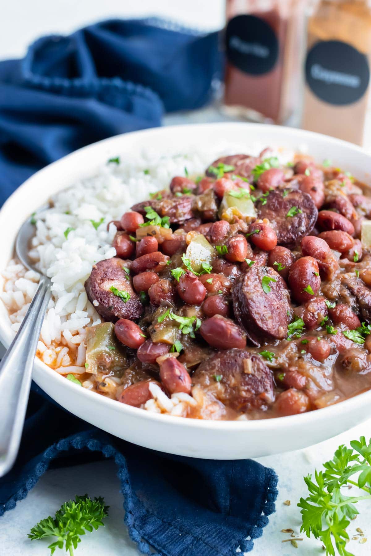 Instant pot red beans and sausage are served with white rice.