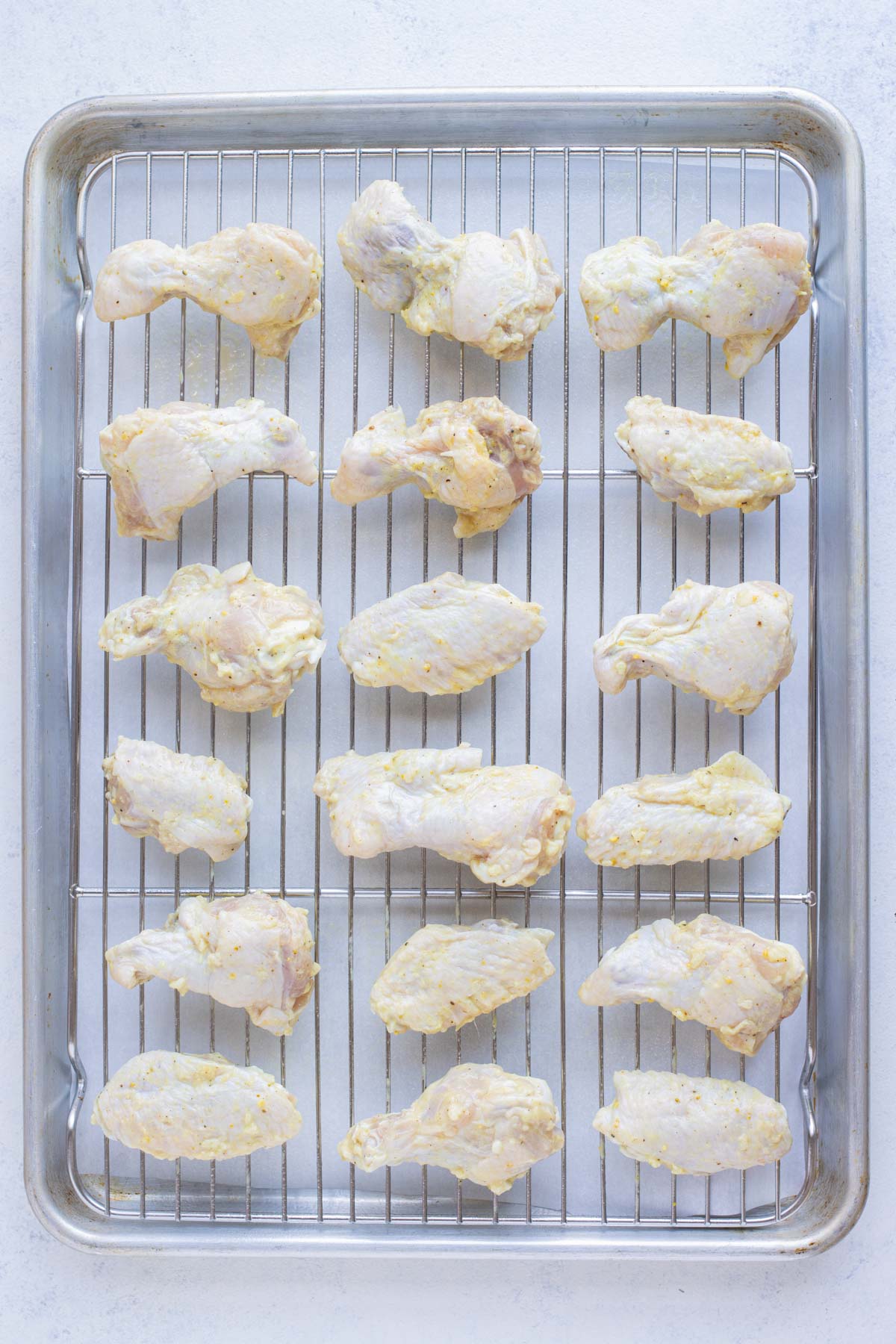 A wire rack is used on the baking sheet before putting in the oven.