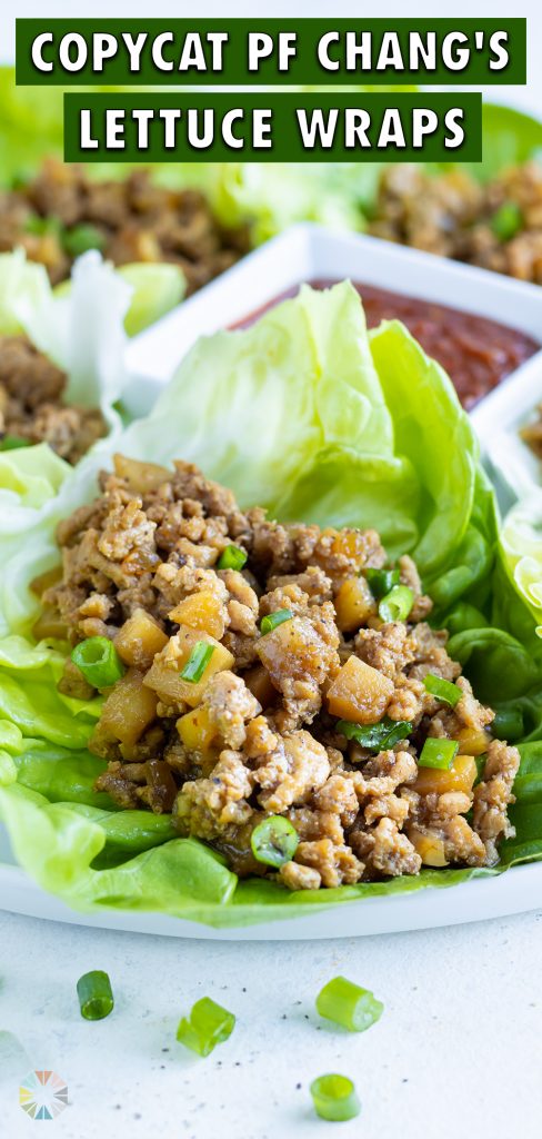 A white plate is filled with copycat PF Chang's Chicken Lettuce Wraps.