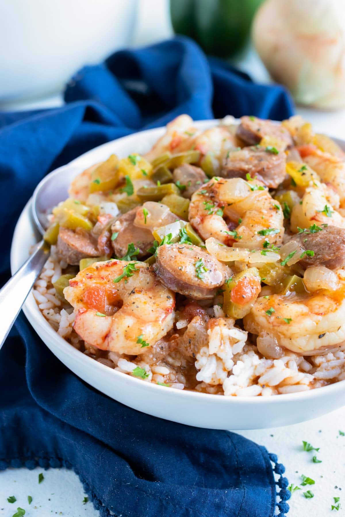 Gumbo made from scratch is placed with rice in a white bowl.