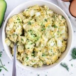 Avocado egg salad is served with a spoon.