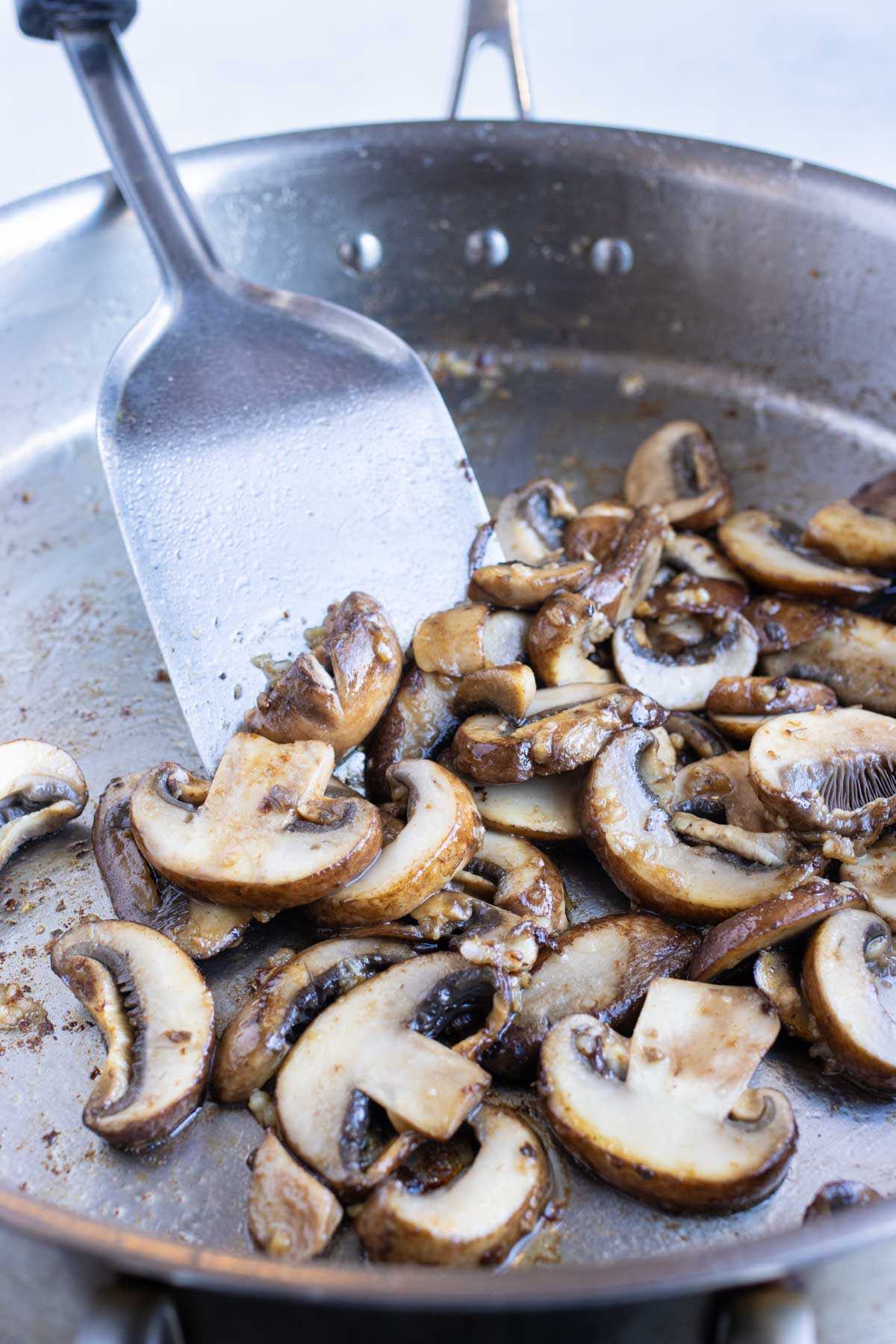 Mushrooms are added to the pan.