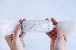 Garlic Herb Butter log is rolled up and kept in the fridge until using.