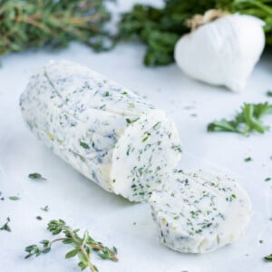 Homemade garlic herb butter is used for vegetables, meats, and breads.